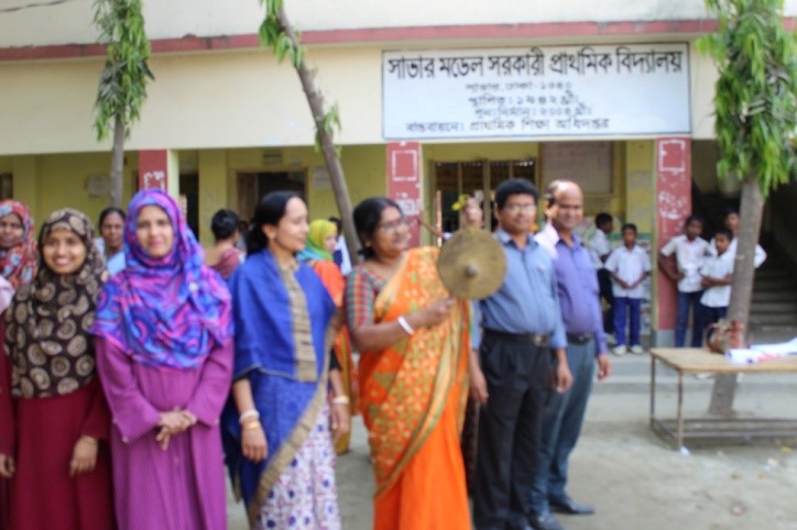 teacher ringing a school bell