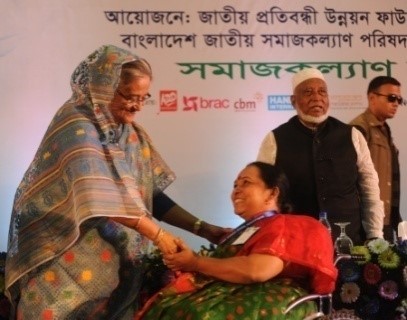 Ms. Mohua Paul receiving Disability Card from the Honorable Prime Minister