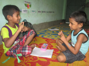 Two deaf children are practicing sign language