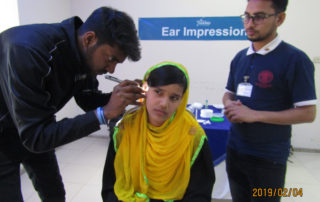doctor checking up a hearing problem patient